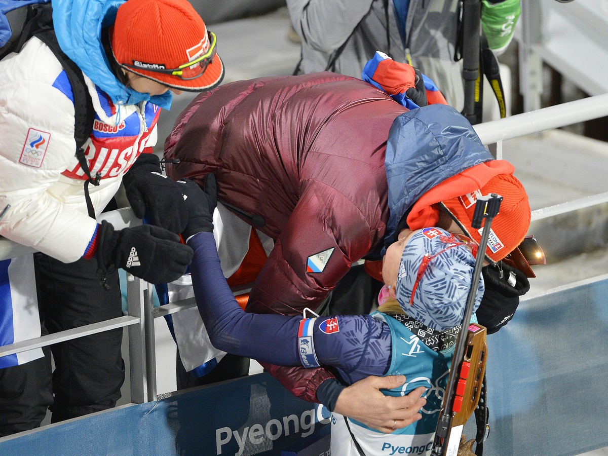 slovenská biatlonistka Anastasia Kuzminová, otec Anton Šipulin a matka Oľga Šipulinová sa objímajú po zisku zlatej olympijskej medaily
