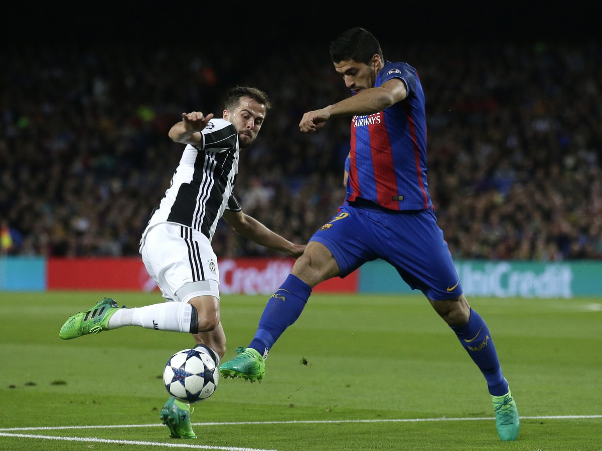 Hráč Barcelony Luis Suarez (vpravo) v súboji s Miralemom Pjaničom z Juventusu