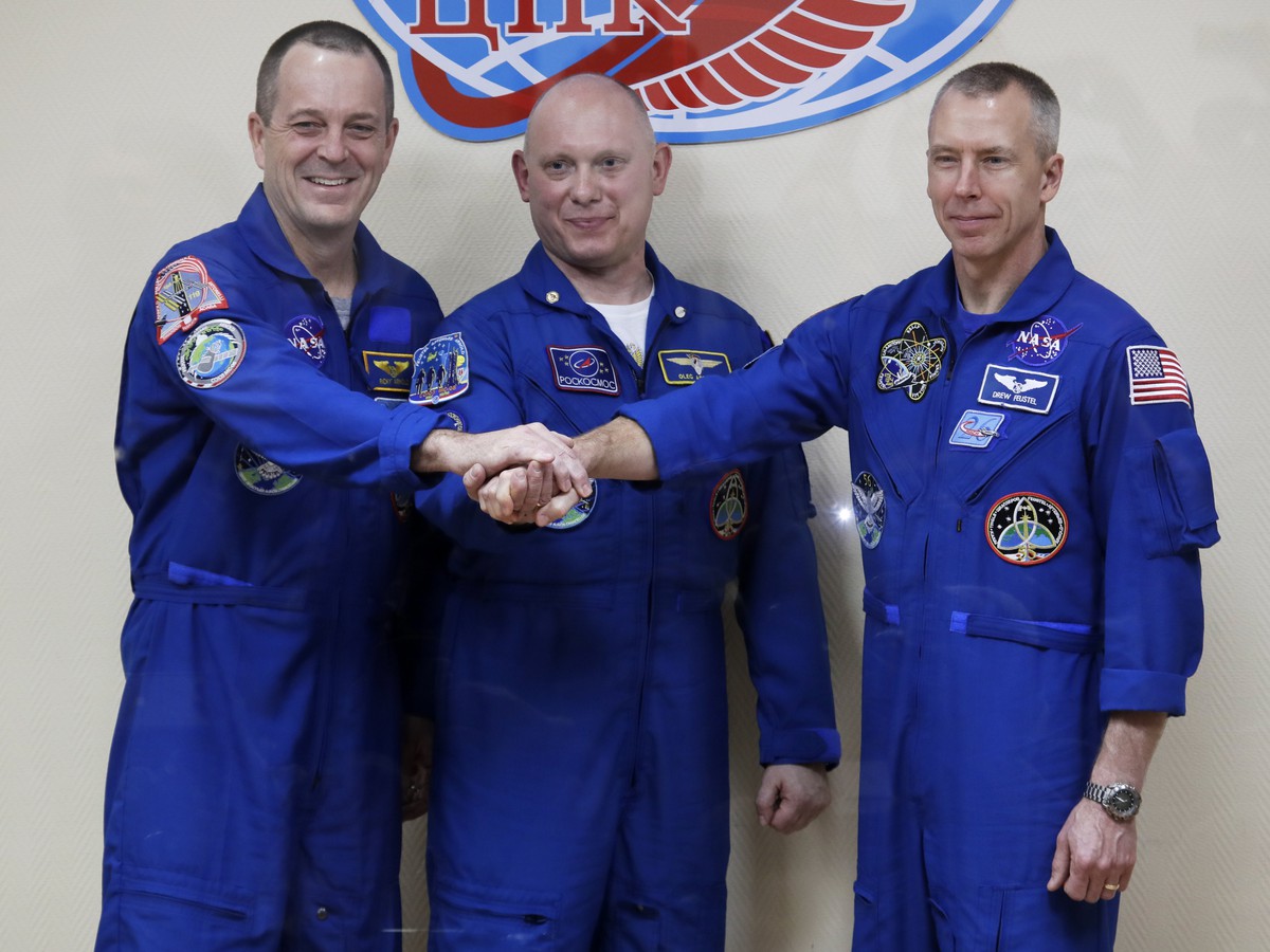 Ruský kozmonaut Oleg Artemjev (uprostred) a americkí astronauti Richard Arnold (vpravo) a  Andrew Feustel počas tlačovej konferencie v ruskom kozmodróme Bajkonur v Kazachstane