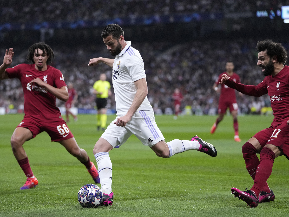 Hráč Liverpoolu Mohamed Salah (vpravo) kričí zatiaľčo Nacho (uprostred) z Realu Madrid kontroluje loptu