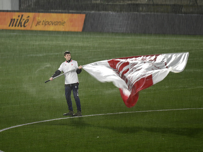 Vlajkonosič mává zástavou v hustom daždi pred začiatkom zápasu 19. kola futbalovej Niké ligy AS Trenčín – FC Košice