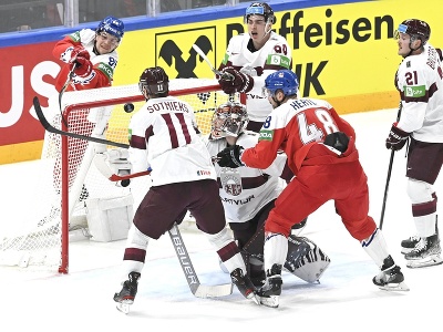 Na snímke vľavo český hráč Matěj Blümel strieľa gól, dole uprostred brankár Lotyšska Elvis Merzlikins