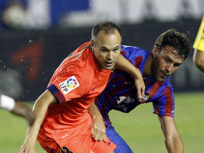 Andrés Iniesta a Victor Casadesus v súboji o loptu