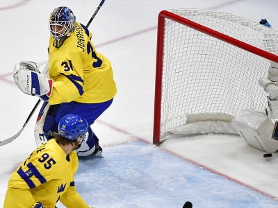 Na snímke vľavo brankár Švédska Lars Johansson inkasuje gól v zápase olympijského turnaja v hokeji mužov o bronz Slovensko - Švédsko na ZOH 2022 v Pekingu