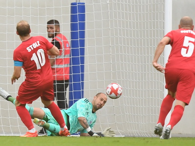 Brankár Slovana Milan Borjan (dole) chytá penaltu, ktorú nepremenil hráč luxemburského FC Swift Hesper Dominik Stolz (vľavo)