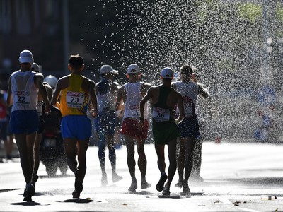 Pretekári kráčajú na trati cez vodnú sprchu počas pretekov v chôdzi mužov na 50 km na ME v atletike v Berlíne