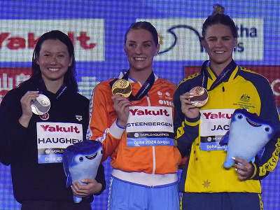 Víťazná holandská plavkyňa Marrit Steenbergenová (uprostred) pózuje na pódiu so zlatou medailou spolu so striebornou Haughey Siobhanovou z Hongkongu (vľavo) a bronzovou Austrálčankou Shaynou Jackovou (vpravo)