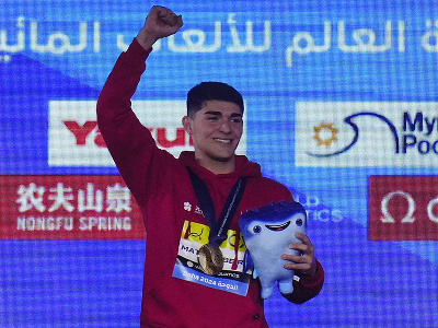 Portugalský plavec Diogo Matos Ribeiro oslavuje na pódiu so zlatou medailou po jeho víťazstve vo finále na 50 m motýlik na MS v plaveckých športoch v katarskom meste Dauhá 12. februára 2024.