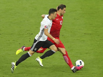 Mesut Ozil a Grzegorz Krychowiak v súboji o loptu