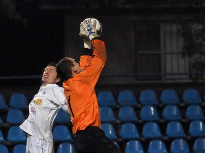 Róbert Rák z FC Nitra (vľavo) vo výskoku v súboji s brankárom Danielom Kissom z MFK Petržalka