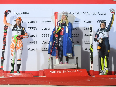 Americká lyžiarka Mikaela Shiffrinová (uprostred) stojí na tróne s korunou na hlave pre Snehovú kráľovnú po víťazstve v slalome žien Svetového pohára v alpskom lyžovaní v Záhrebe . Druhá skončila Slovenka Petra Vlhová (vľavo), tretia bola Švédka Anna Swennová-Larssonová (vpravo).