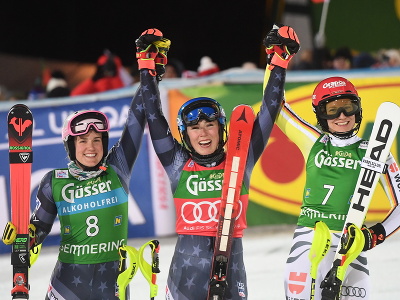 Na snímke uprostred americká lyžiarka Mikaela Shiffrinová oslavuje víťazstvo v nočnom slalome žien Svetového pohára v alpskom lyžovaní v rakúskom Semmeringu vo štvrtok 29. decembra 2022. Vľavo druhá jej krajanka Paula Moltzanová, vpravo tretia Nemka Lena Dürrová