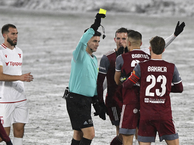 Uprostred hlavný rozhodca udeľuje žltú kartu hráčovi Mikulášovi Bakaľovi (FK Železiarne Podbrezová)