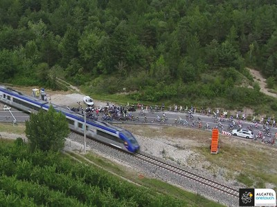 Pelotón bol na Tour de France zastavený na priecestí vlakom.