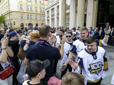 Oslavujúci hokejisti HC Slovana Bratislava s majstrovskou trofejou zdravia fanúšikov pred Primaciálnym palácom