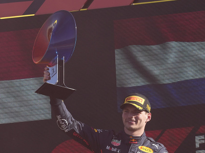 Max Verstappen a jeho víťazné oslavy na pódiu s víťaznou trofejou