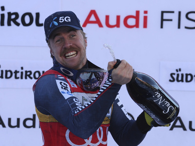 Nór Aleksander Aamodt Kilde strieka šampanské na pódiu po triumfe v zjazde Svetového pohára alpských lyžiarov v talianskom stredisku Val Gardena