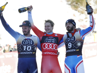 Uprostred švajčiarsky lyžiar Marco Odermatt oslavuje víťazstvo v zjazde Svetového pohára vo Wengene, vľavo druhý Francúz Cyprien Sarrazin, vpravo tretí Talian Dominik Paris.