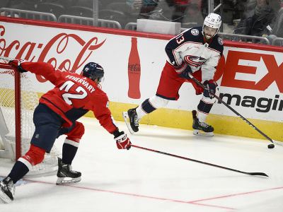 Johnny Gaudreau za bránkou Capitals bránený Martinom Fehérvárym 