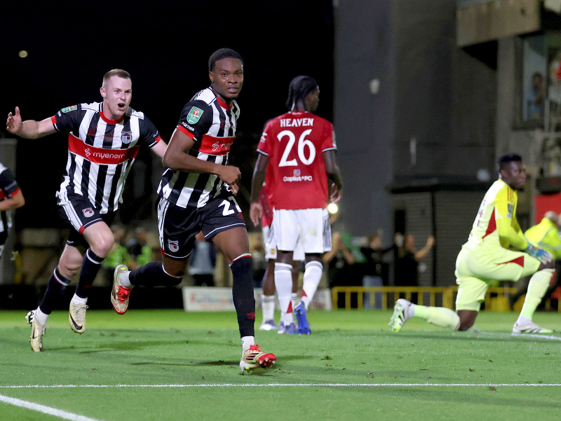 Hráč Grimsby Town Tyrell Warren (uprostred) oslavuje gól