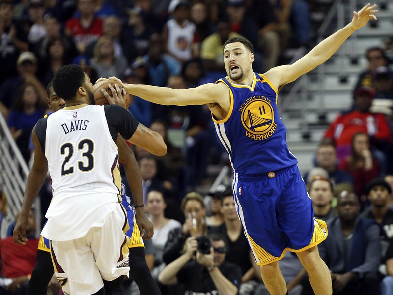 Klay Thompson sa snaží zablokovať strelu Anthonyho Davisa