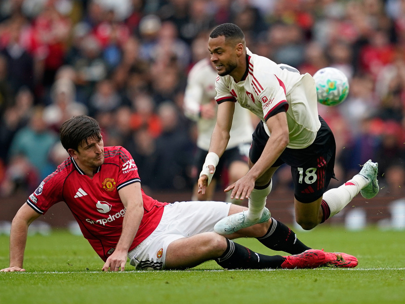Harry Maguire a Cody Gakpo v súboji o loptu