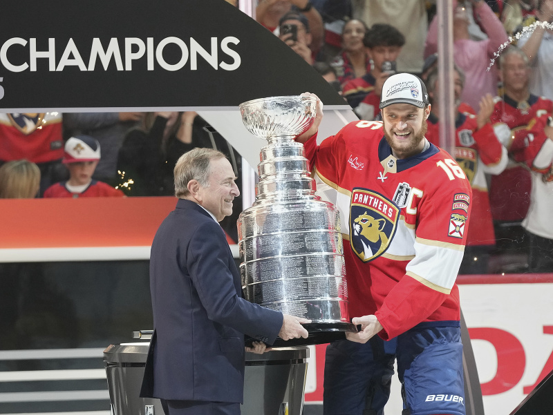 Kapitán Floridy Aleksander Barkov preberá Stanley Cup z rúk Garyho Bettmana, komisára NHL