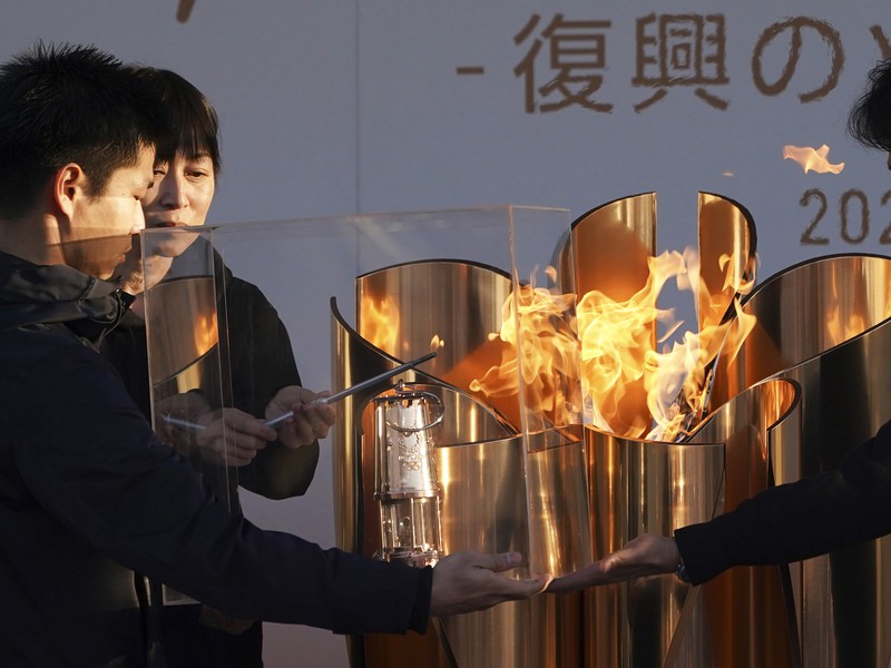 Zapálenie lampy olympijským ohňom na záver slávnostného ceremoniálu „Plameň obnovy“ v japonskom meste Iwaki