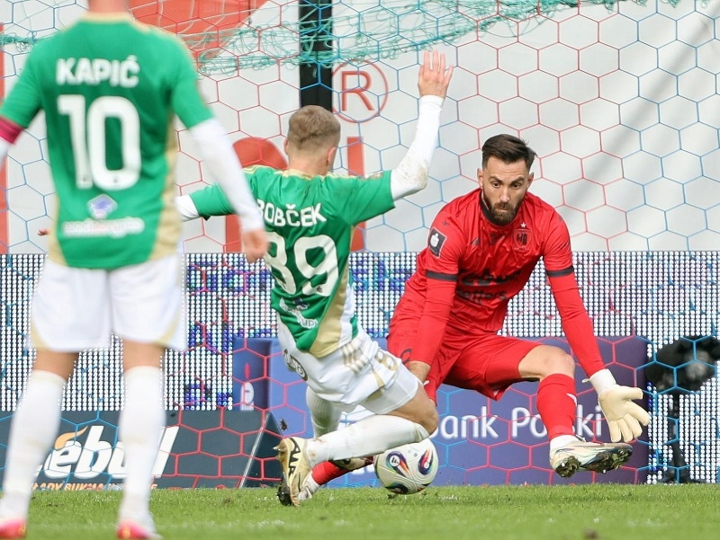 Slovenský brankár v drese Piastu Gliwice František Plach (vpravo), ktorému strieľa víťazný gól slovenský futbalový reprezentant v drese Lechie Gdansk Tomáš Bobček (uprostred)
