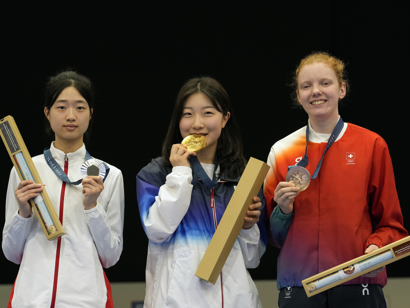 Juhokórejská reprezentantka v športovej streľbe Ban Hyo-jin (uprostred) pózuje so zlatou medailou
