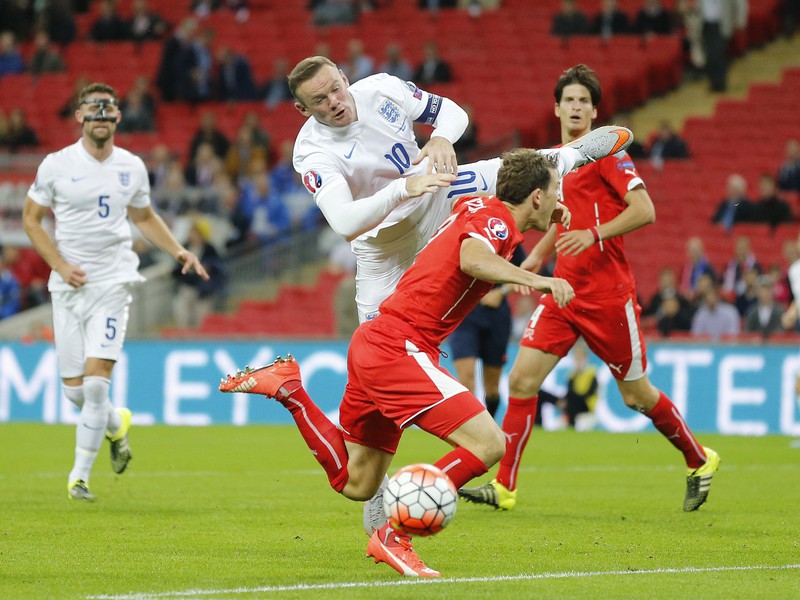 Wayne Rooney a Stephan Lichtsteiner v súboji o loptu